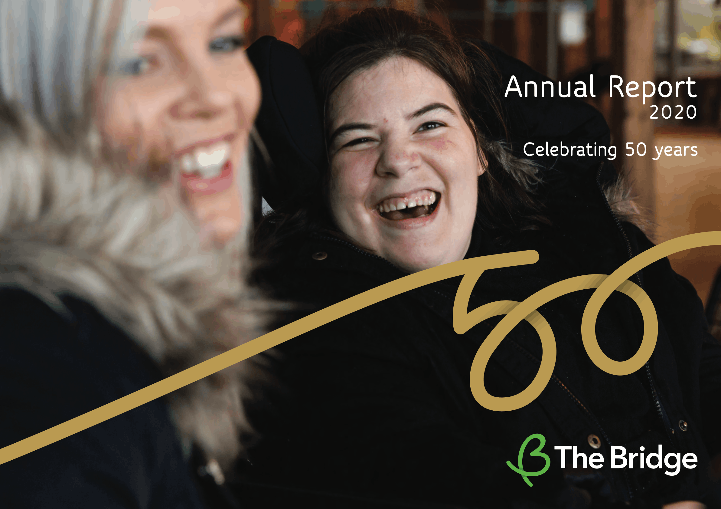 Two women laughing together, cover of The Bridge Annual Report 2020, celebrating 50 years