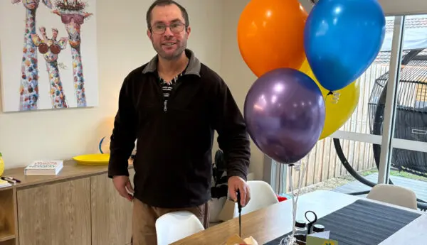 Man stands by a table with a 