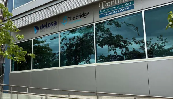 Office building facade with signs for Delosa Design Services, The Bridge Employment, and Portmin Accounting & Finance.